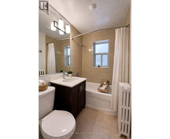 A bathroom with a toilet, sink, and bathtub.