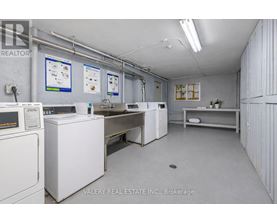 A brokerage office with white appliances and a white wall.