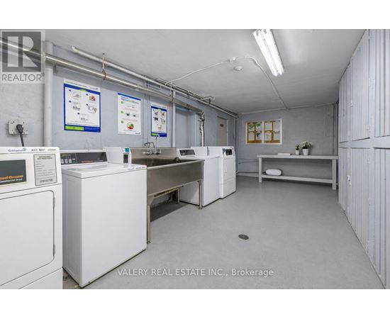 A brokerage office with white appliances and a white wall.