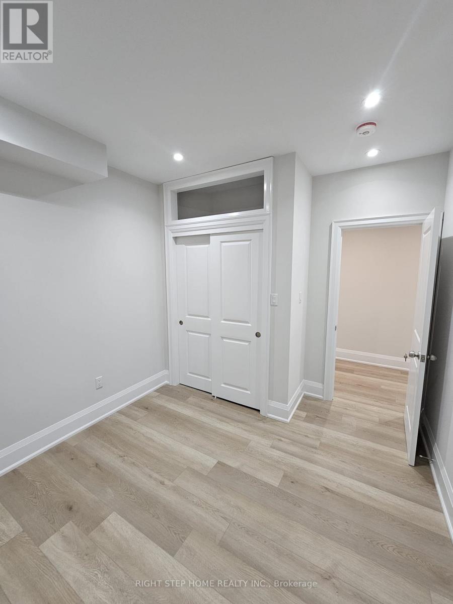 A white door is in a room with wood flooring.