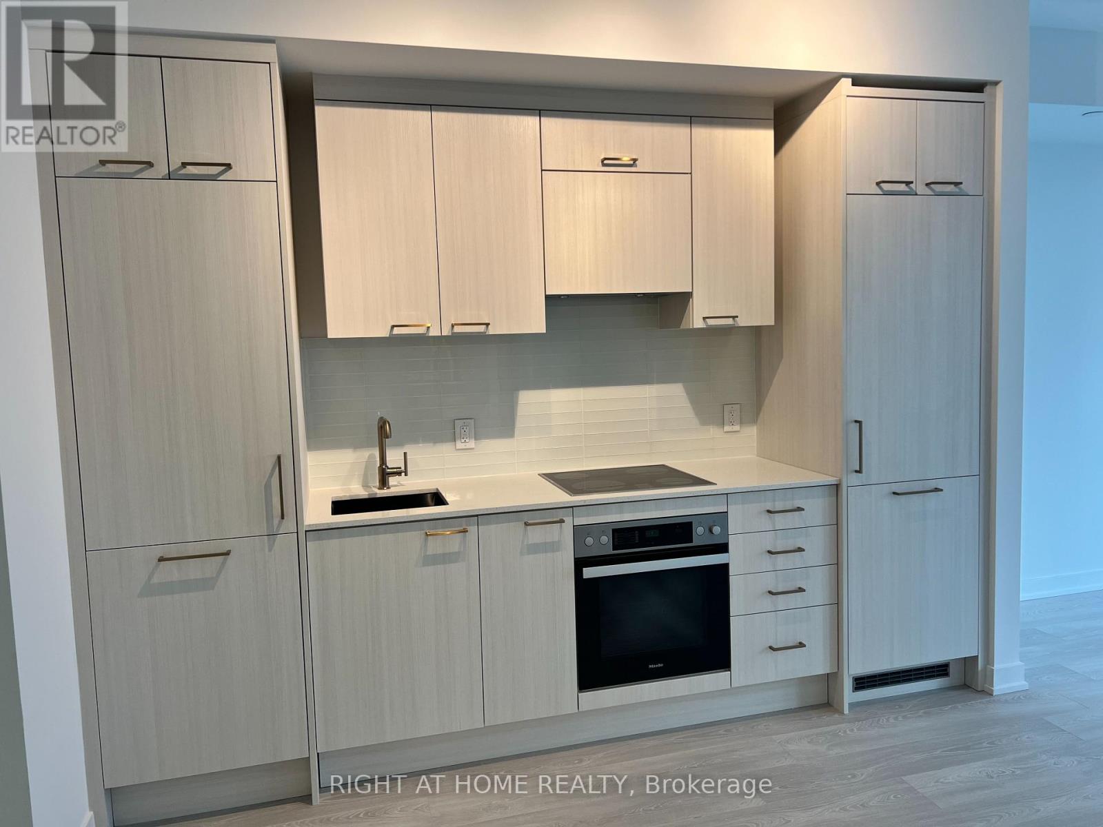 A modern kitchen with wooden cabinets and stainless steel appliances.