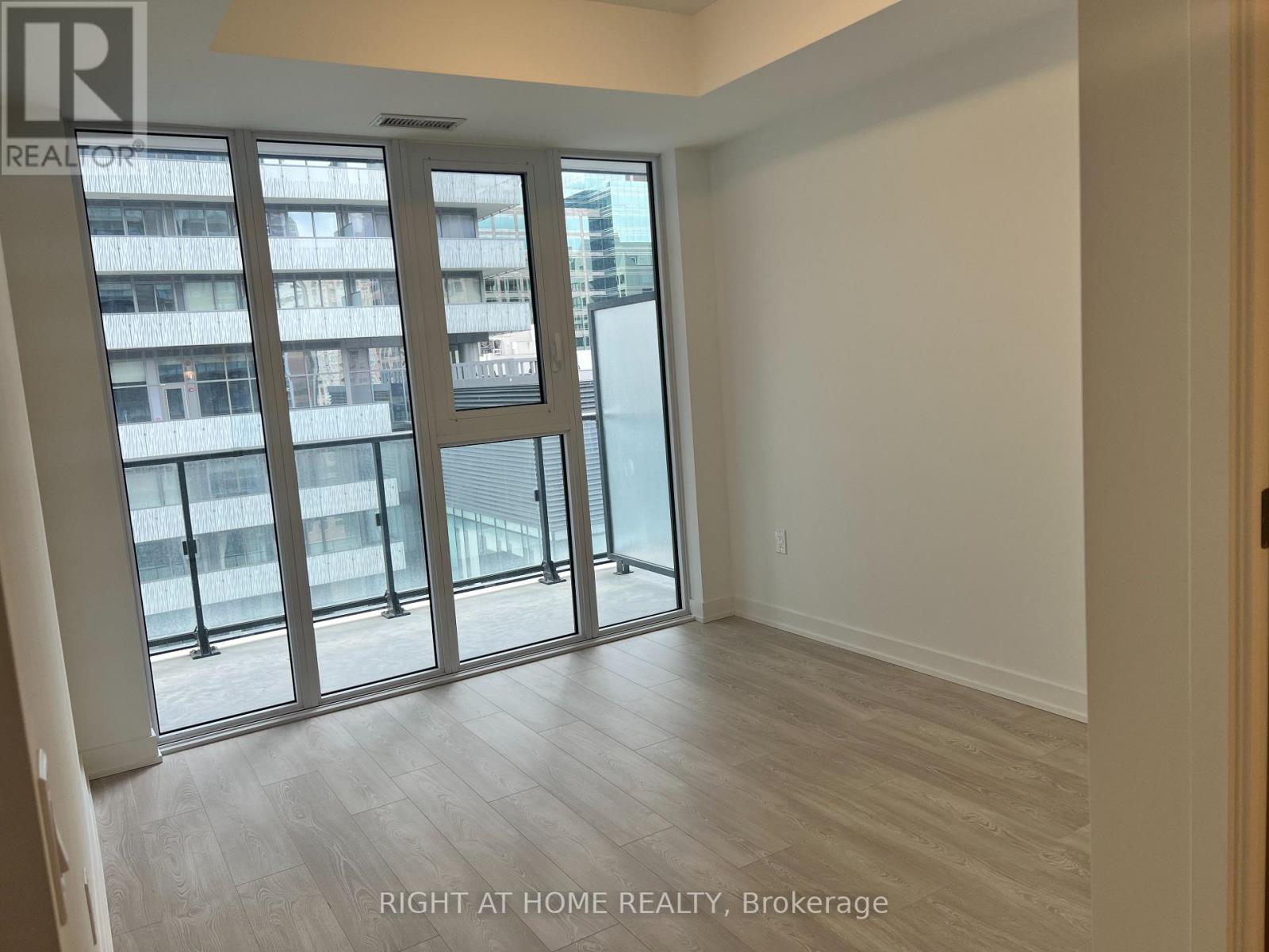 A room with a large window and a sliding glass door.
