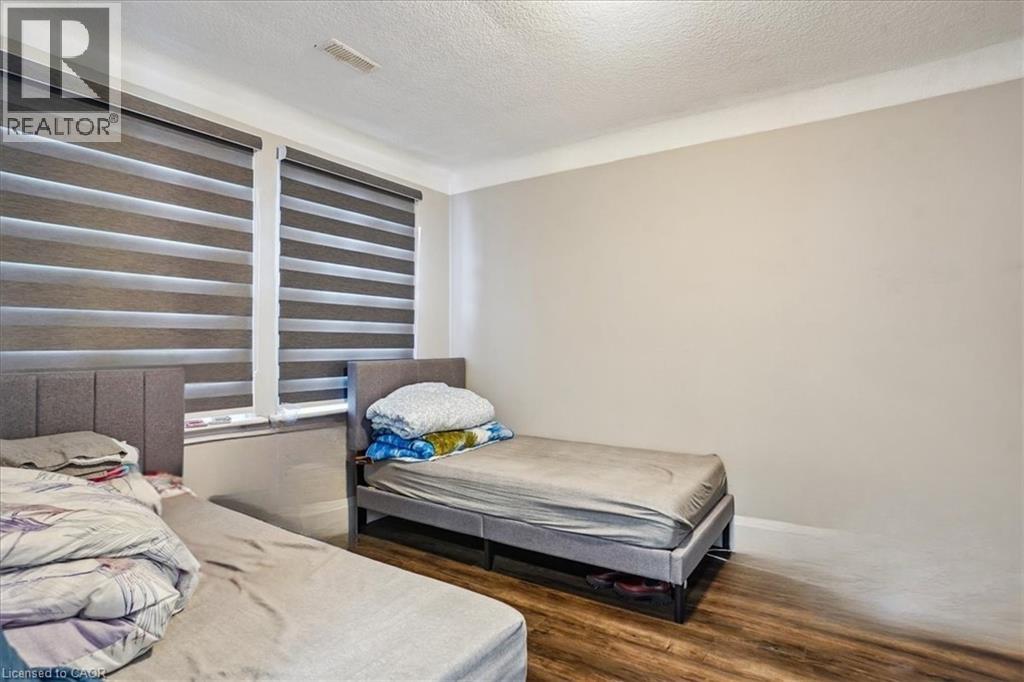A bedroom with a bed and a single bed with a pillow on it.