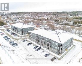 A snowy landscape with a building and cars parked in front.