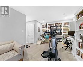 A home gym with a treadmill, exercise ball, and weights.