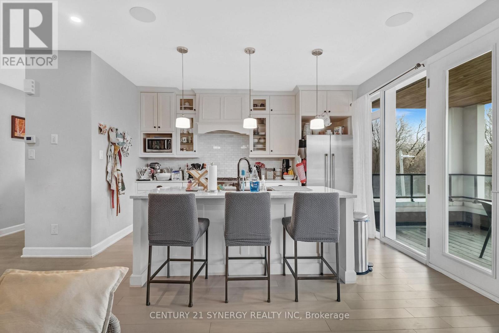 A kitchen with a table and chairs in front of it.