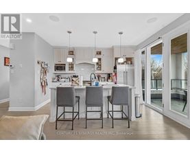 A kitchen with a table and chairs in front of it.