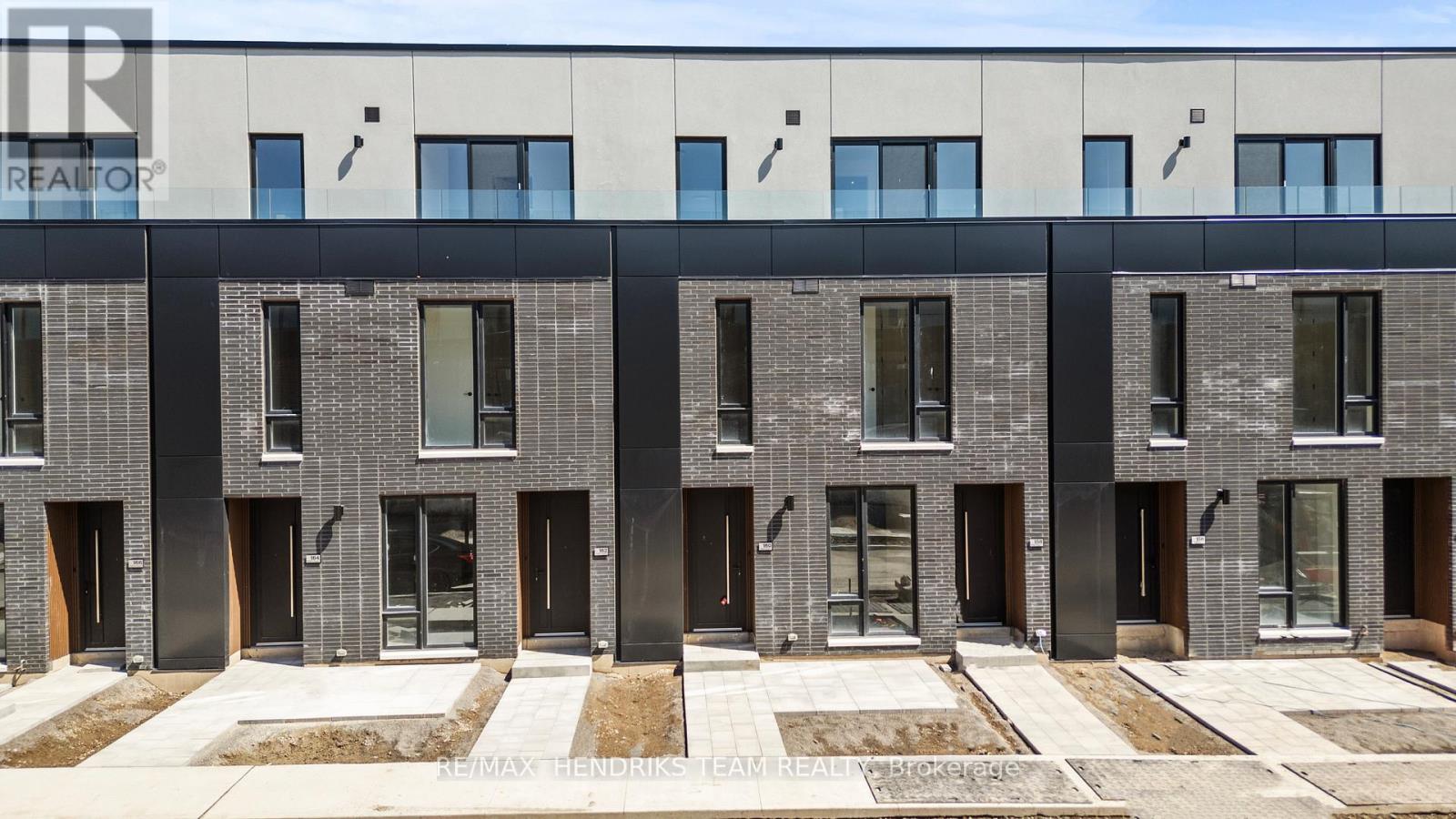 A building with a grey facade and black doors and windows.