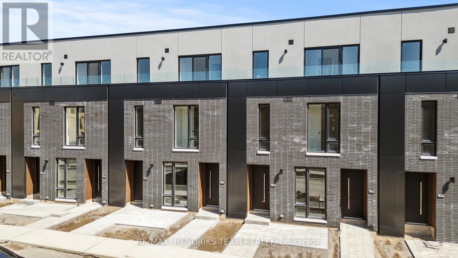 A modern building with a row of windows and doors.