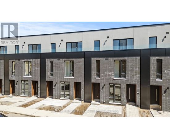 A modern building with a row of windows and doors.