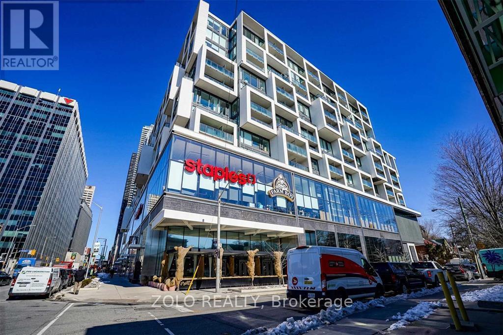 A tall building with a sign that says "Staybridge Suites" on it.