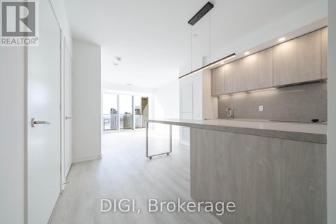 A modern kitchen with white cabinets and a countertop.