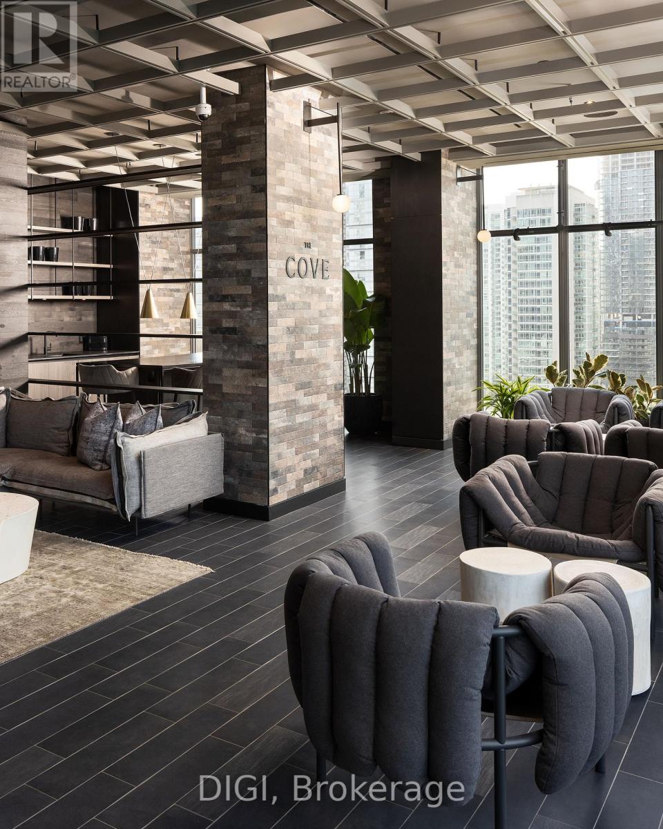 A modern living room with a stone pillar and grey furniture.