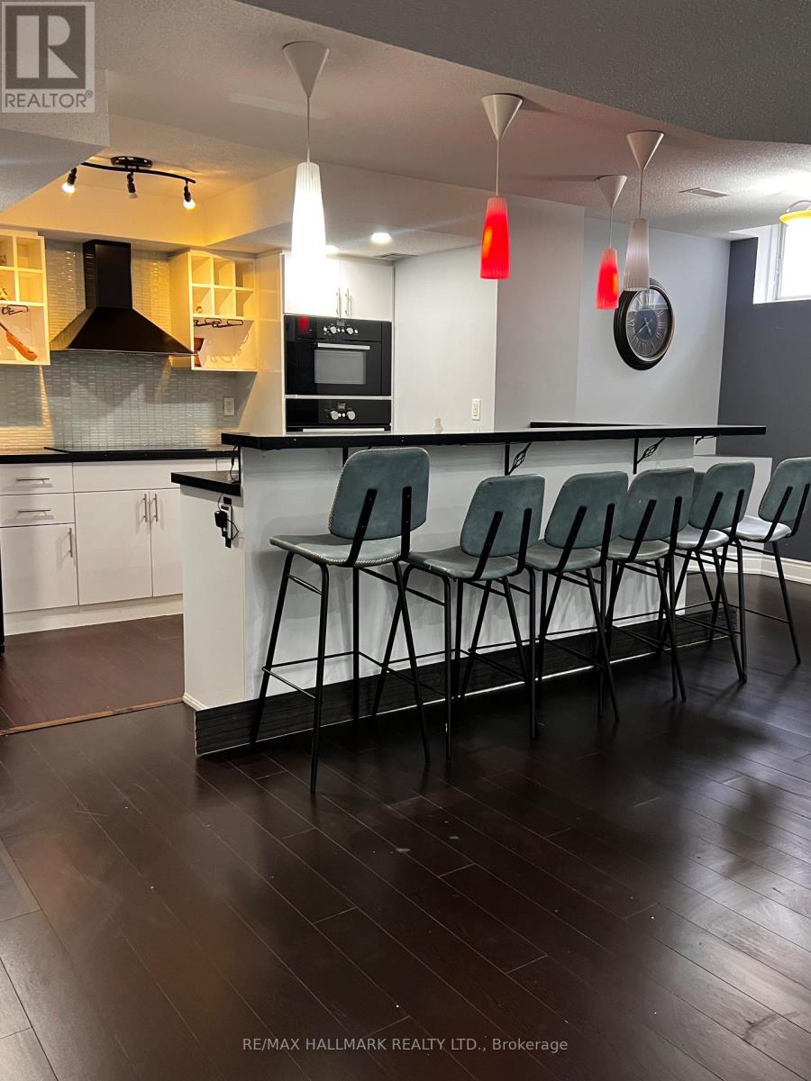 A kitchen with white cabinets and a black counter top.