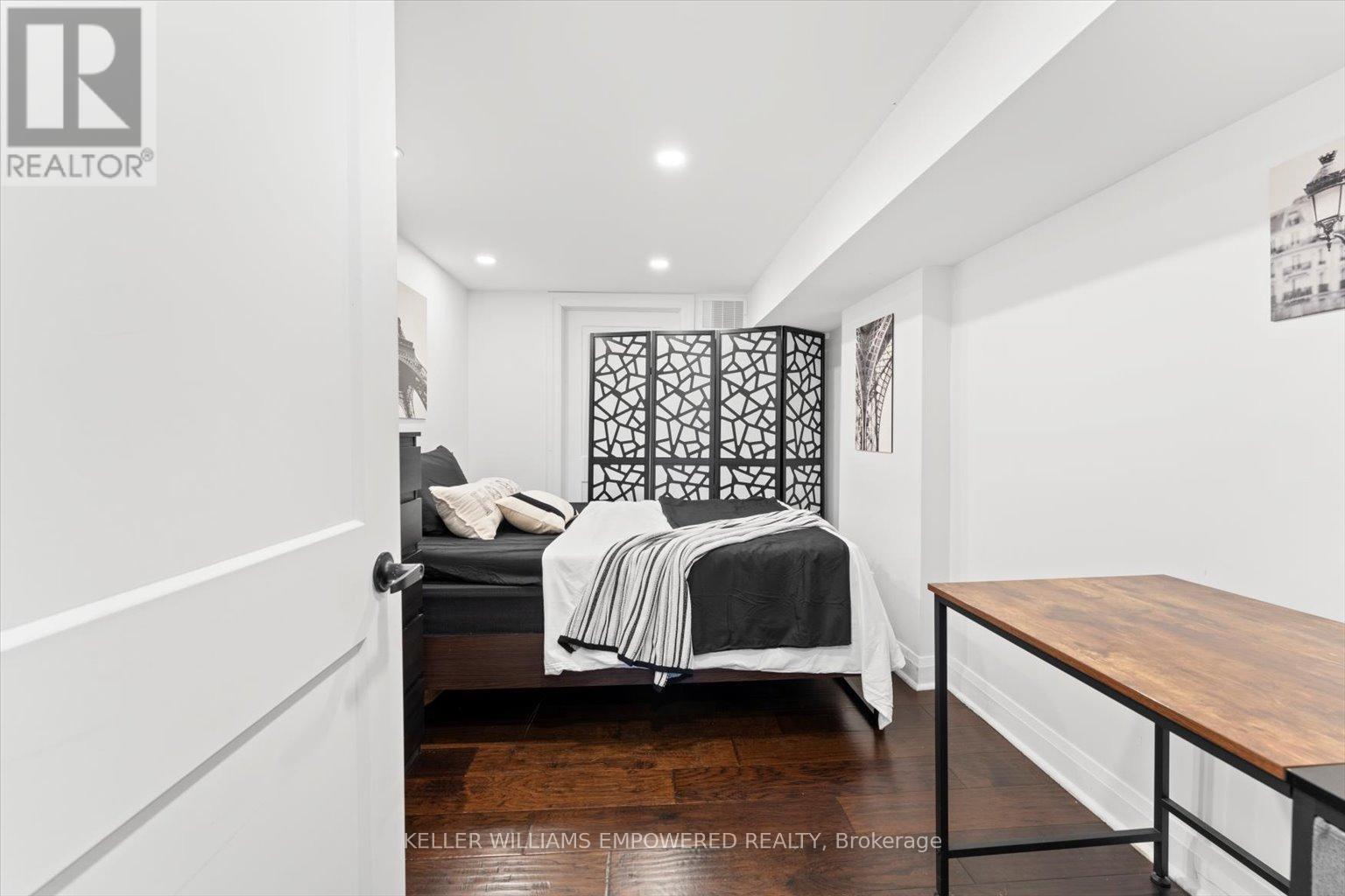 A bedroom with a bed and a lamp.