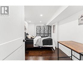 A bedroom with a bed and a lamp.