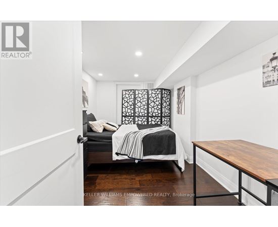 A bedroom with a bed and a lamp.