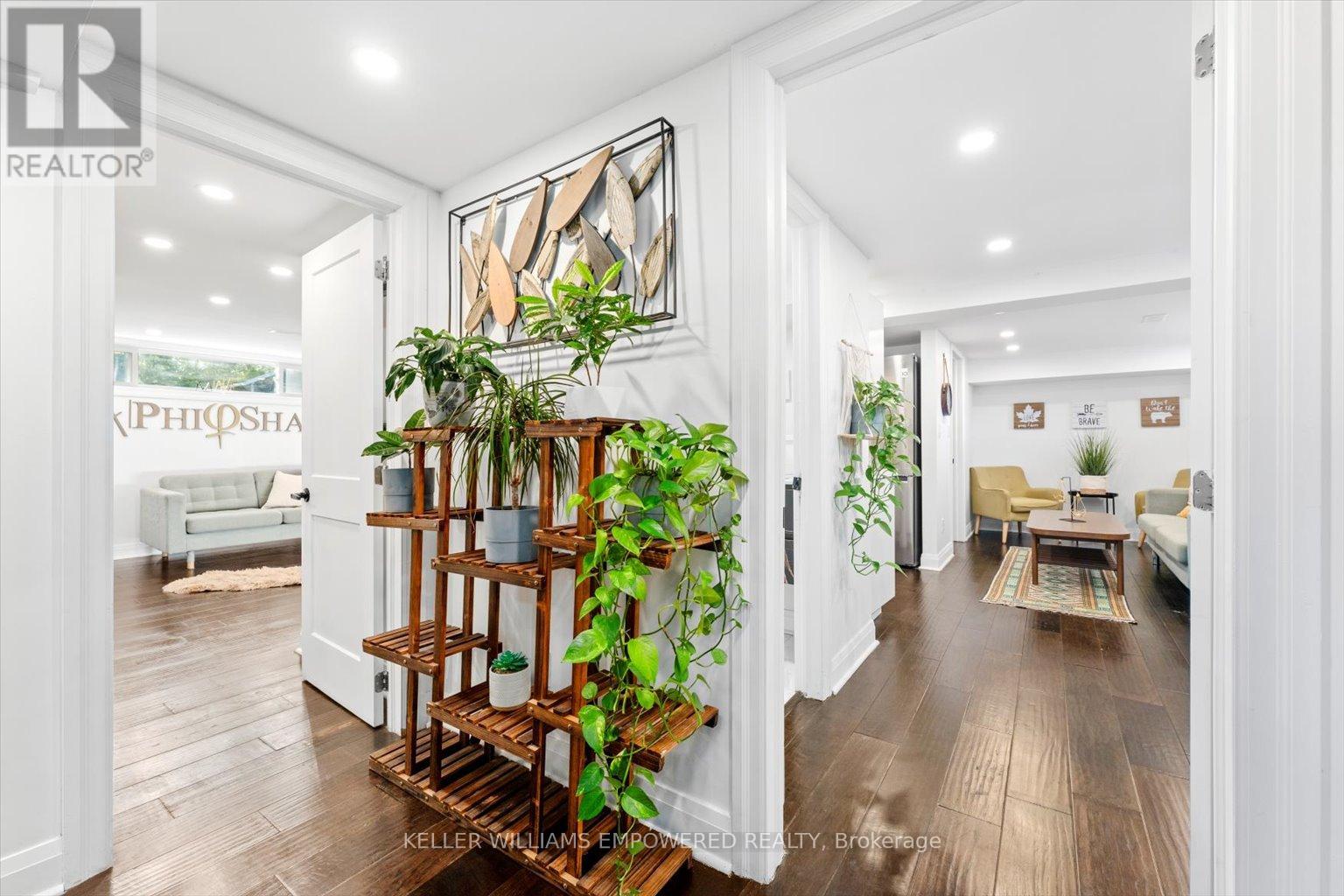 A living room with a wooden floor and a white wall.