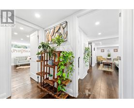 A living room with a wooden floor and a white wall.