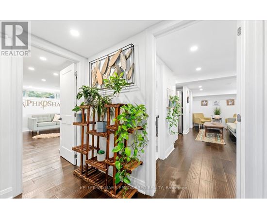 A living room with a wooden floor and a white wall.