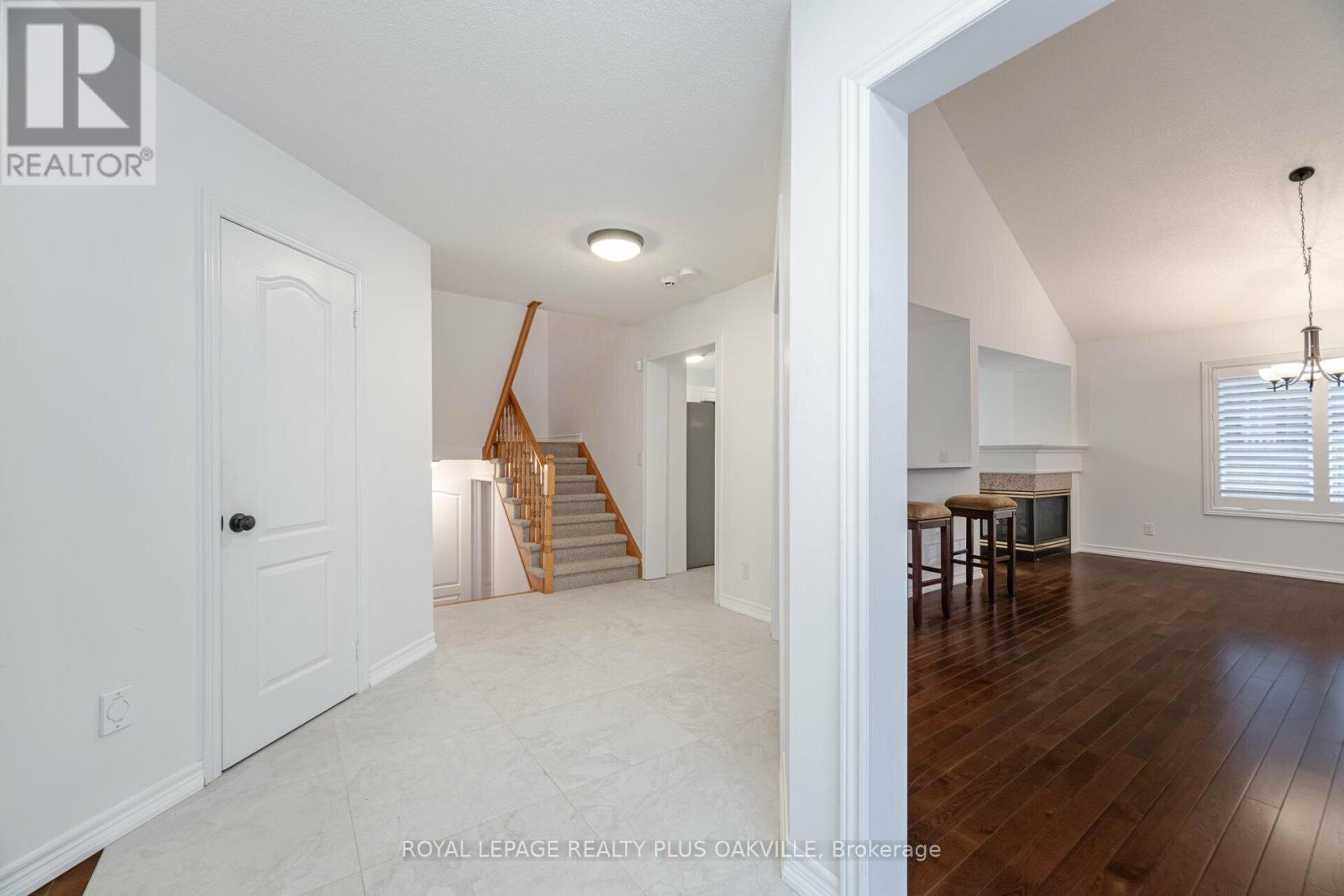 A spacious room with a staircase and a dining area.