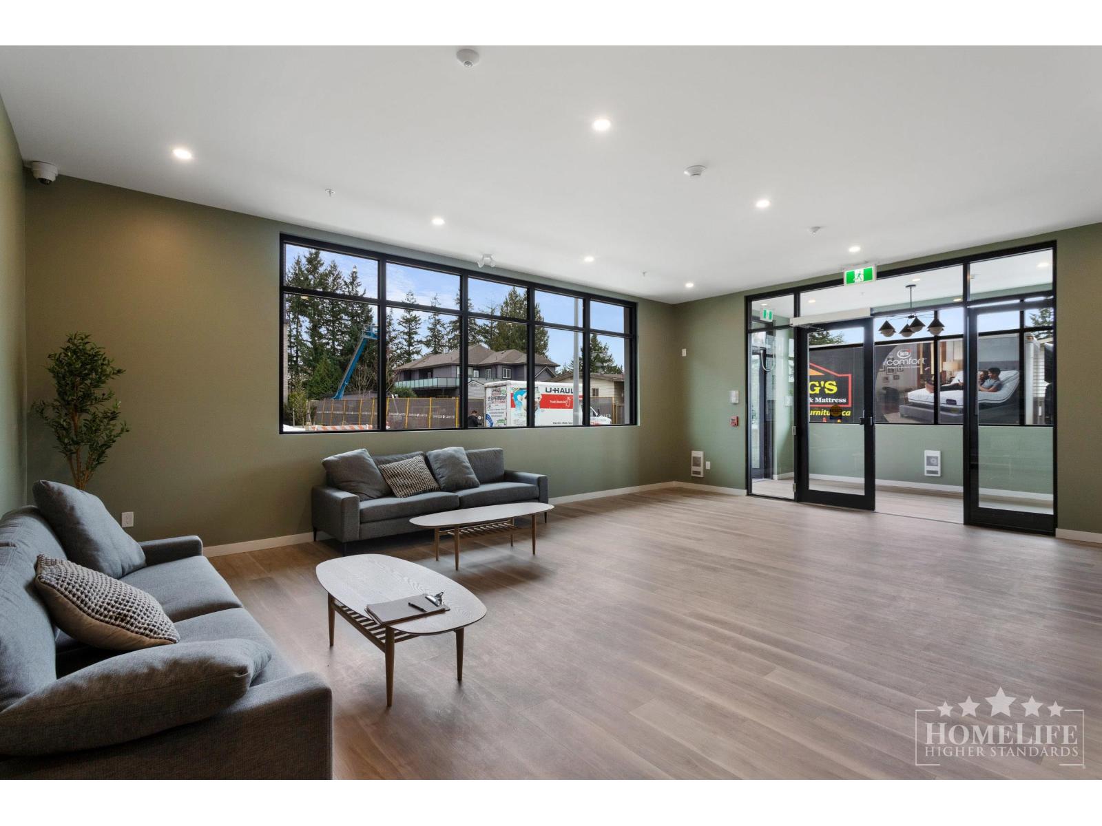 A living room with a grey couch and a coffee table.