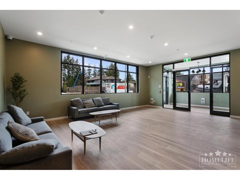 A living room with a grey couch and a coffee table.