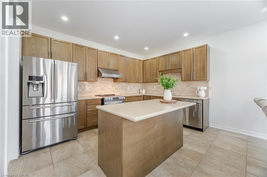 A modern kitchen with wooden cabinets and stainless steel appliances.