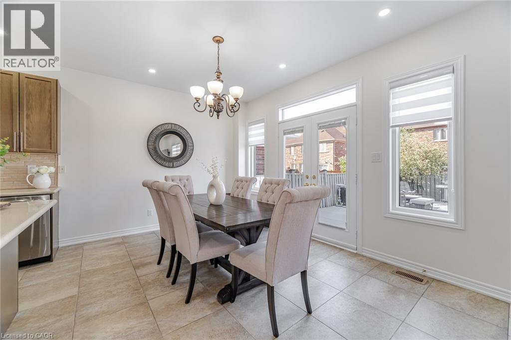A dining room with a table set for six.