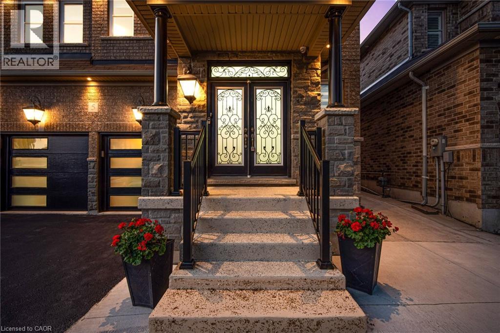 A house entrance with a glass door and steps leading up to it.
