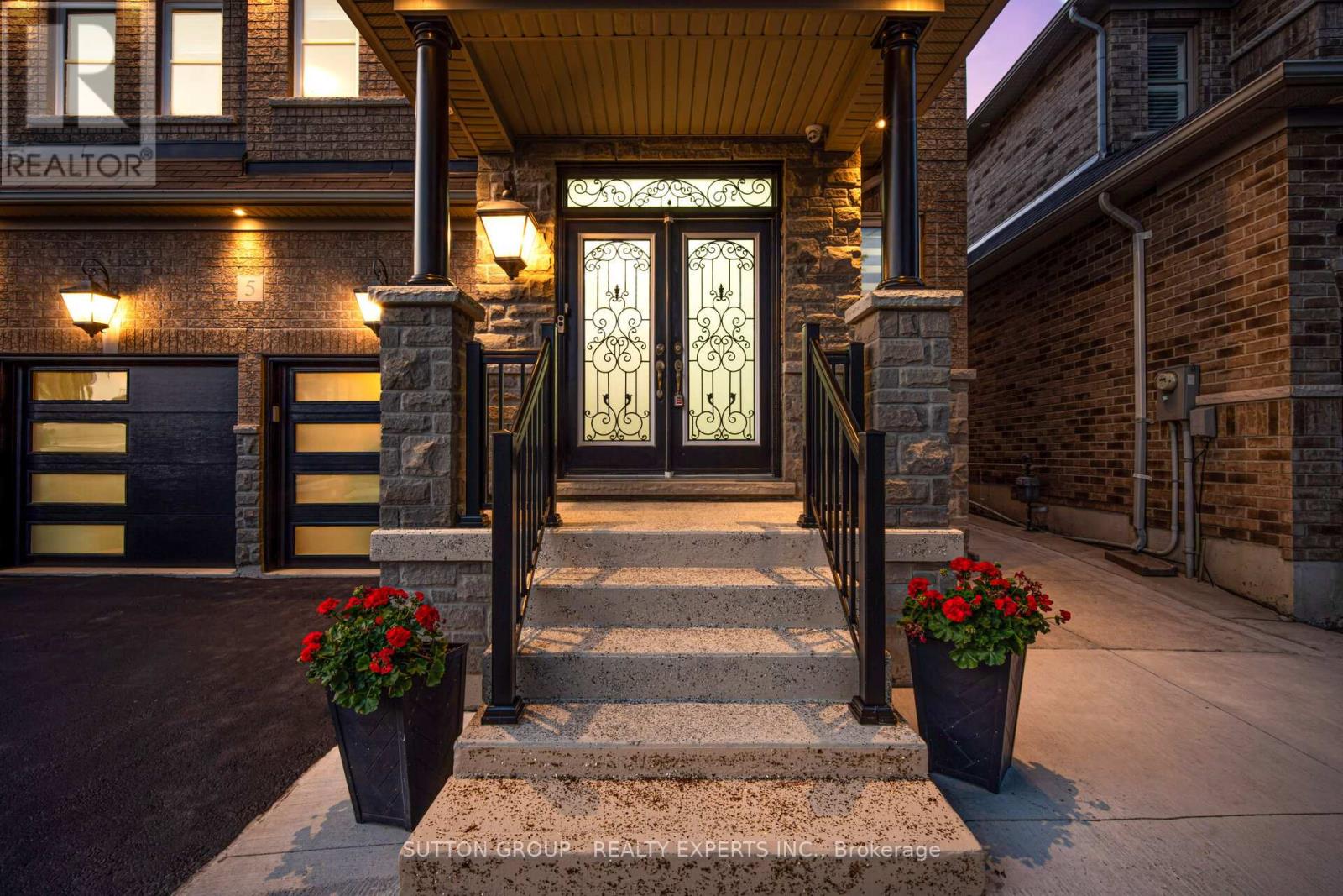 A house entrance with a glass door and steps leading up to it.
