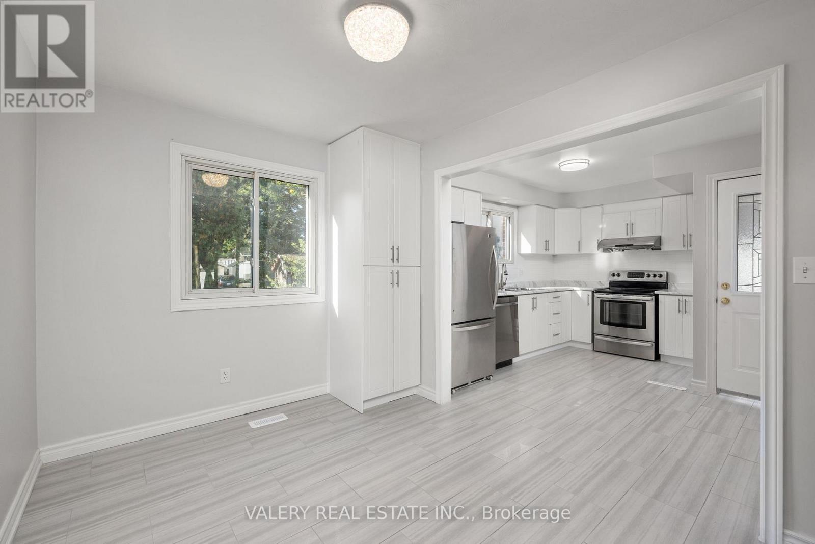 A kitchen with white cabinets and stainless steel appliances.