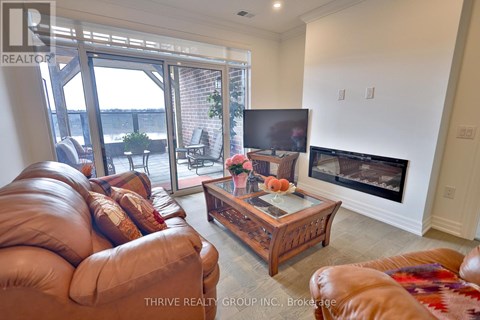 A living room with a brown leather couch and a wooden coffee table.