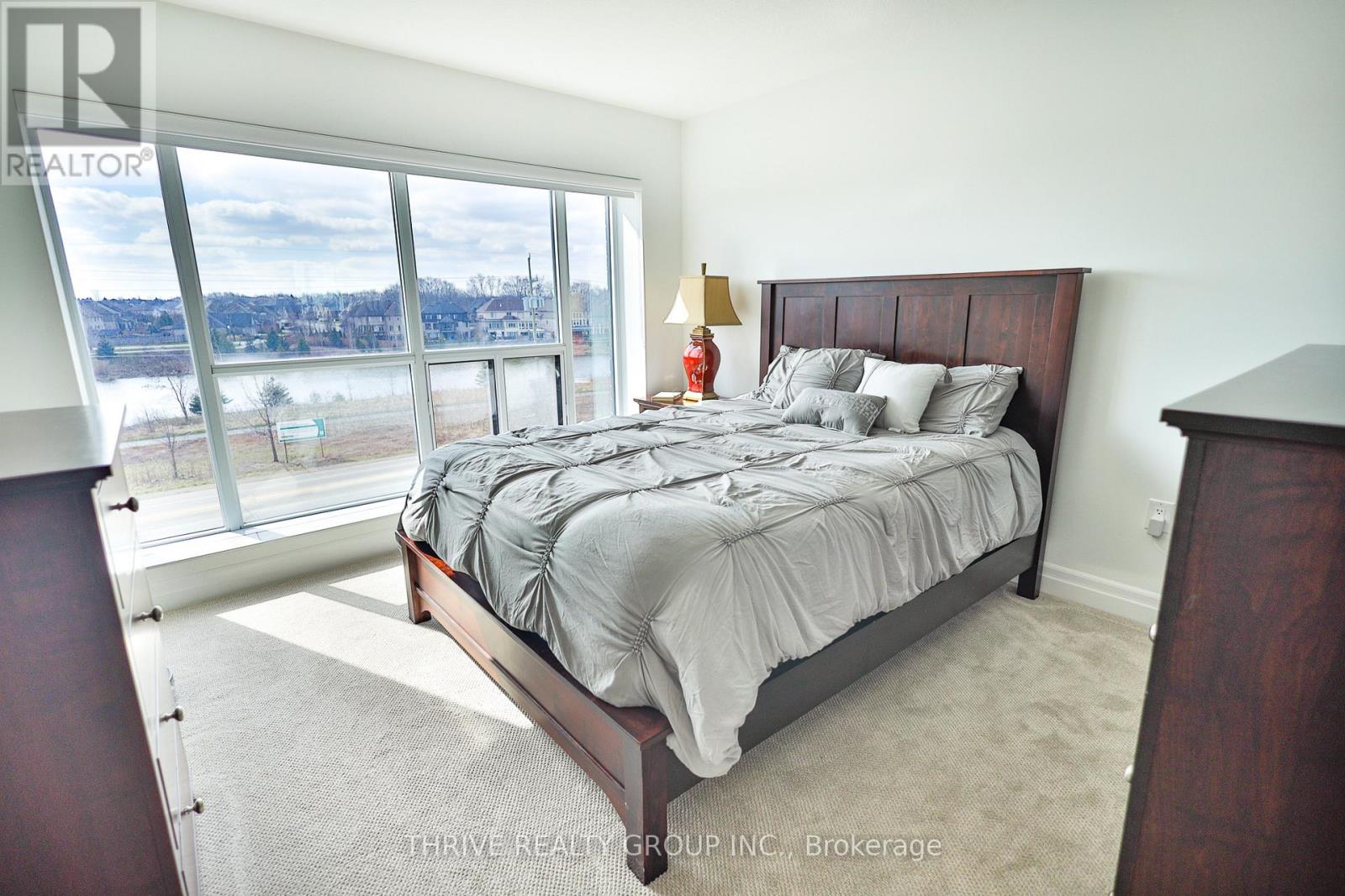 A bedroom with a large bed and a view of the city.