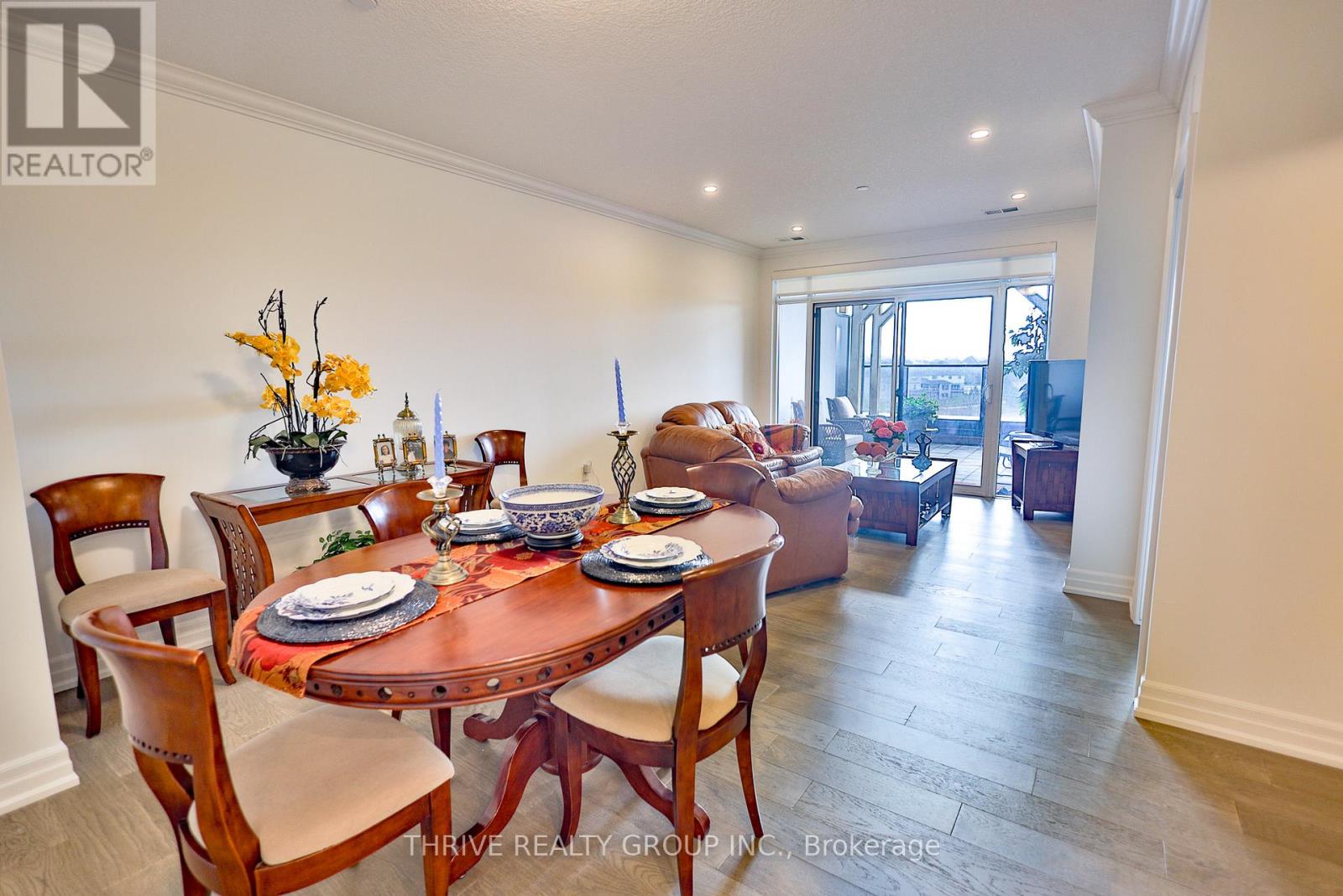 A dining room with a table set for six.
