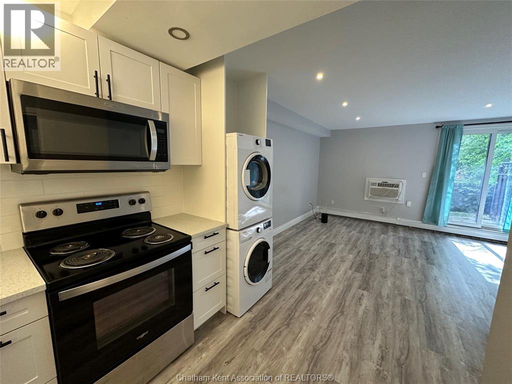 A kitchen with a stove top oven, microwave, and dishwasher.