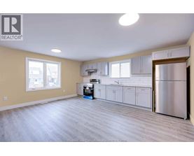 A kitchen with a refrigerator, dishwasher, and oven.