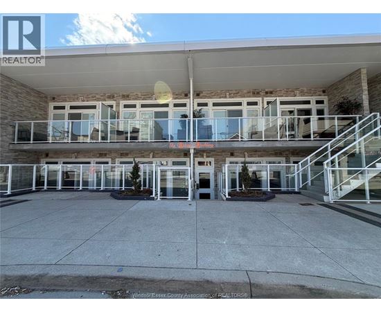 A building with a balcony and a glass door in front.