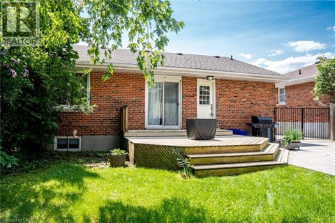 A red brick house with a white door and a small porch.