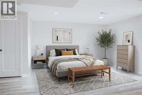 A bedroom with a large bed and a wooden bench.