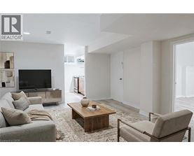A living room with a grey couch, a wooden coffee table, and a television.