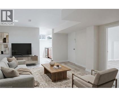 A living room with a grey couch, a wooden coffee table, and a television.