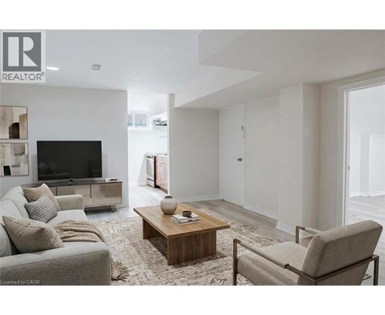 A living room with a grey couch, a wooden coffee table, and a television.