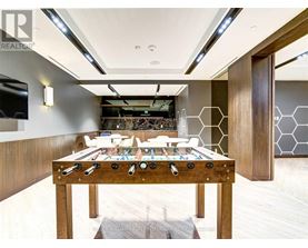 A billiard table with a pool table in the middle of the room.