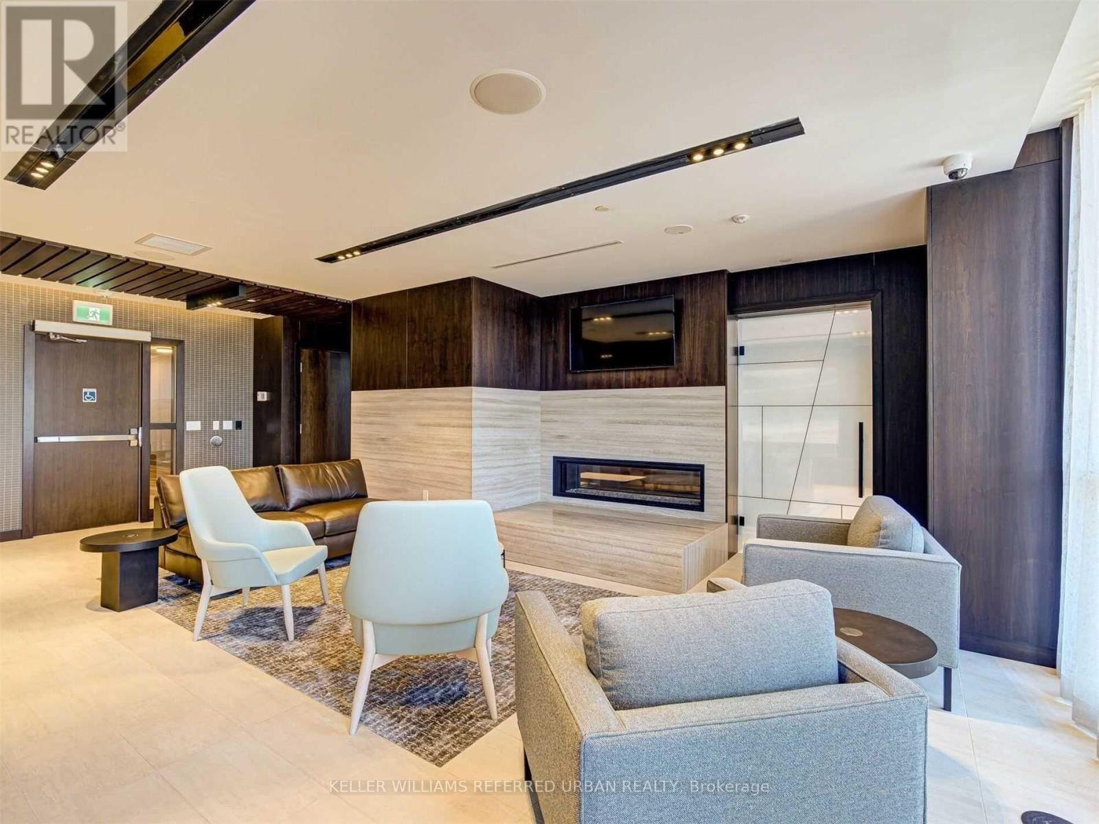 A modern living room with a fireplace and a television.