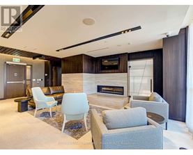 A modern living room with a fireplace and a television.