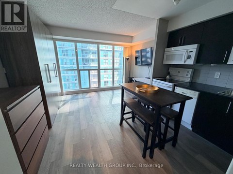 A kitchen with a table and chairs in front of a window.