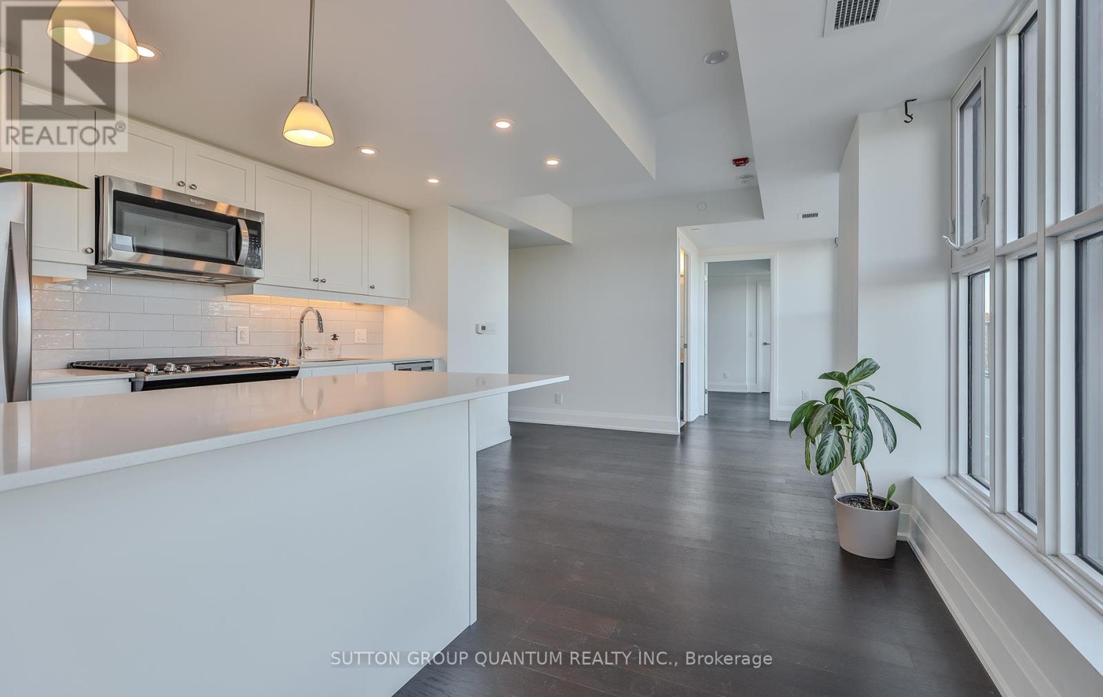 A modern kitchen with white cabinets and a wooden countertop.