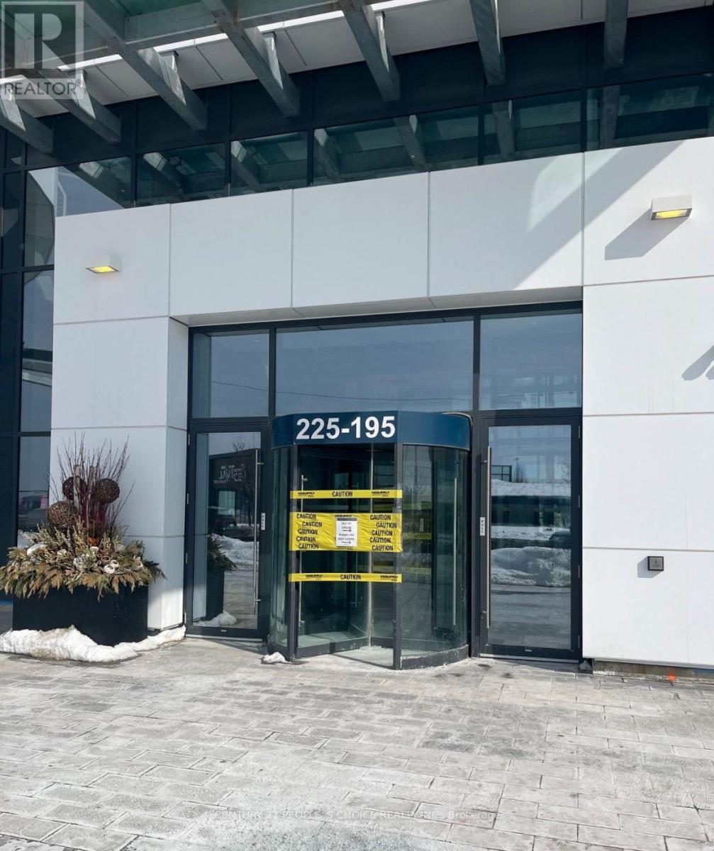 The entrance to a building with a glass door and a yellow sign on it.