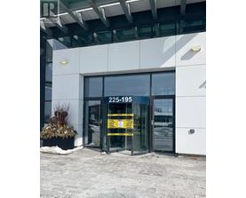 The entrance to a building with a glass door and a yellow sign on it.